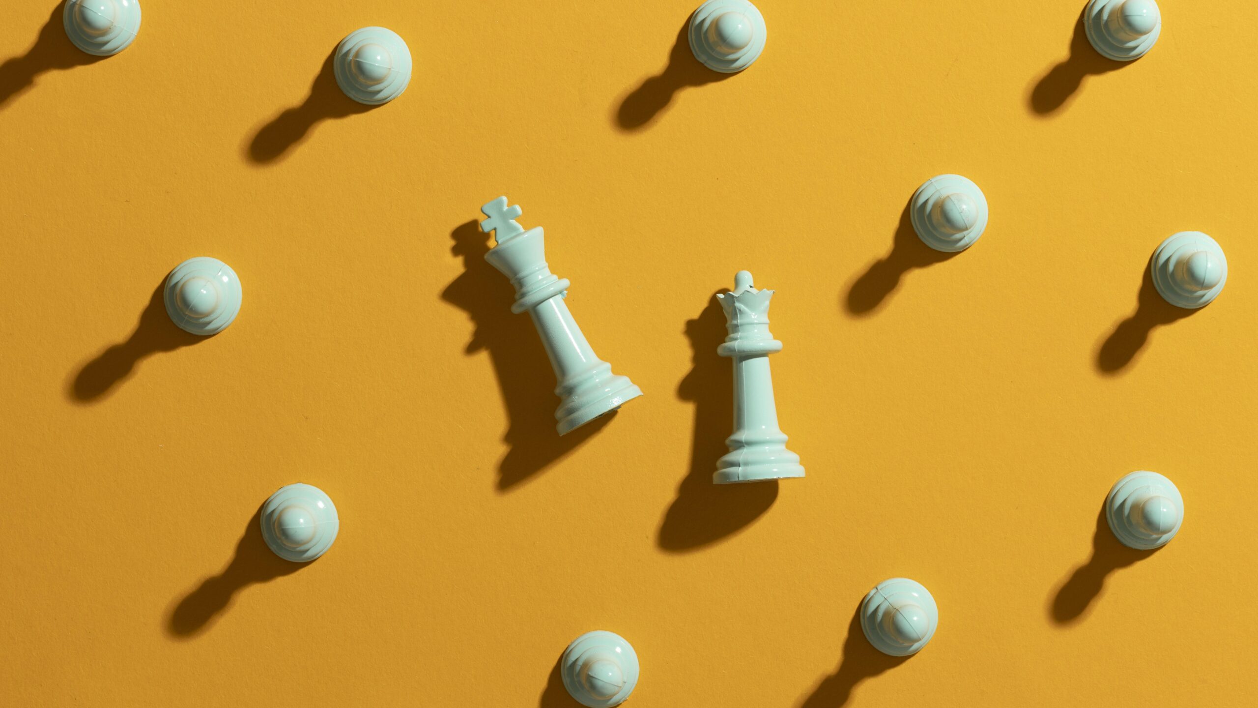 white-chess-pieces-yellow-background